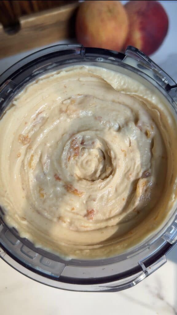 Peach‑infused high‑protein ice cream base after mixing caramelized peaches in Ninja Creami.