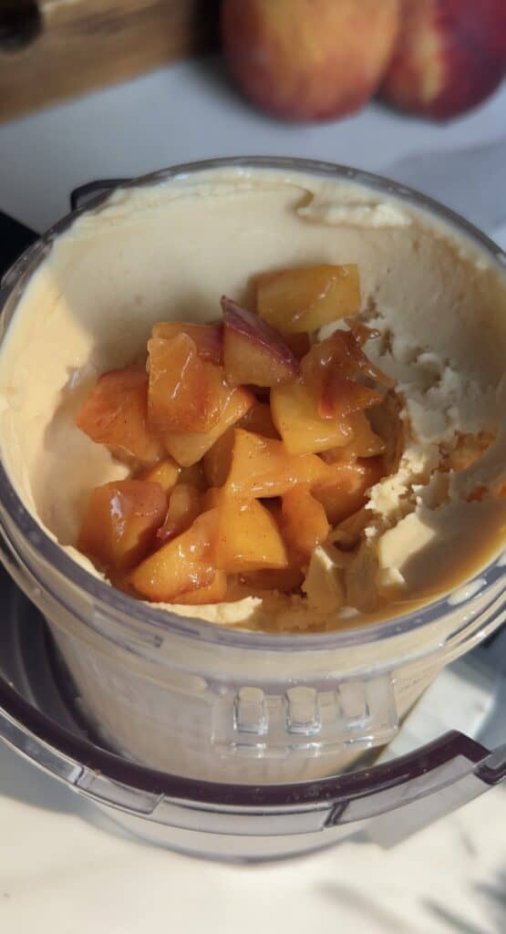 Caramelized peaches added to creamy Ninja Creami base for high‑protein peach cobbler ice cream
