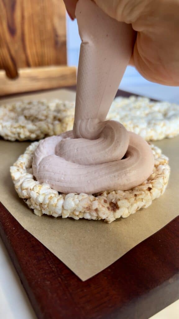 High‑protein strawberry shortcake rice cake topped with Greek yogurt frosting and crumble
