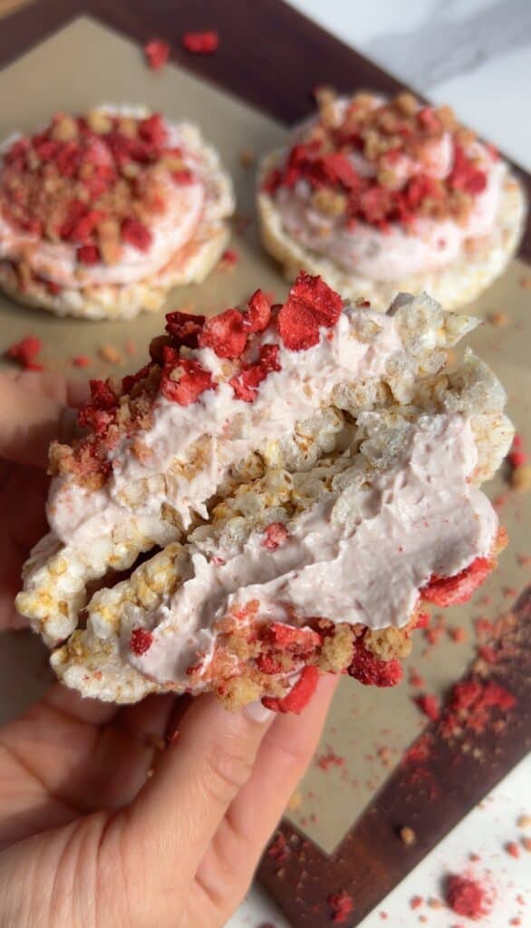 High‑protein strawberry shortcake rice cake topped with Greek yogurt frosting and crumble