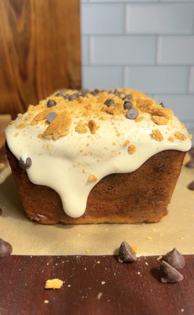 Banana bread topped with white chocolate, graham crackers, and chocolate chips.