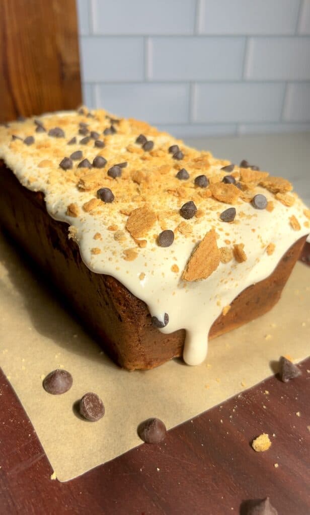 Banana bread topped with marshmallows, chocolate chips, and graham cracker crumbs.