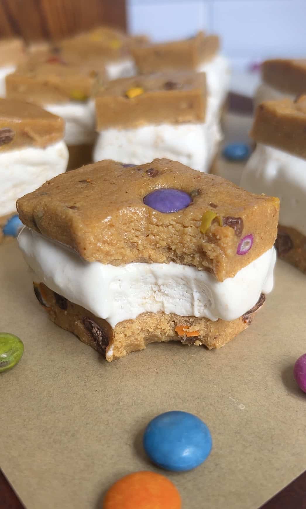 Bite shot of cookie dough ice cream sandwiches highlighting creamy texture of filling