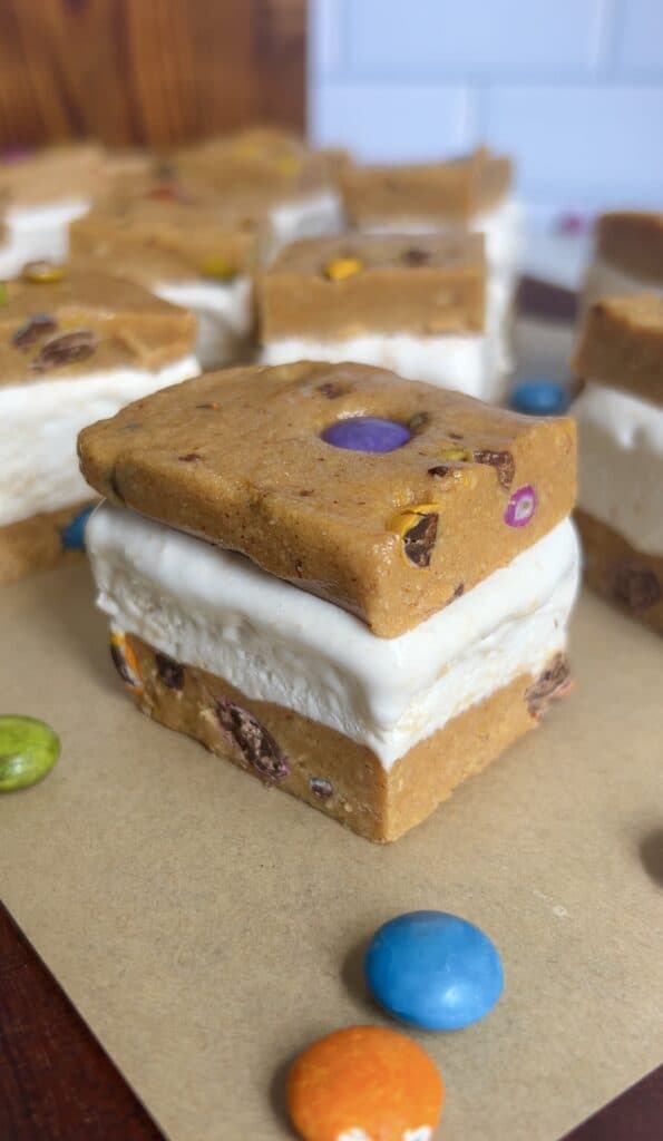 Close up shot of the creamy cool whip ice cream filling between 2 cookie dough layers