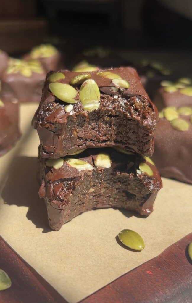 Chocolate energy bites with pumpkin seeds on top, close-up view.