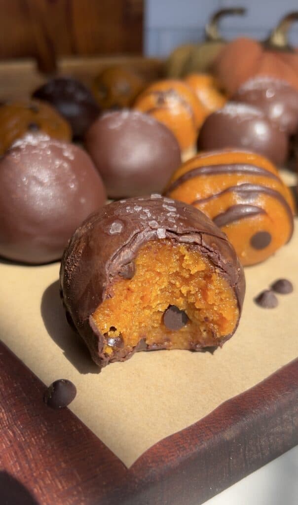 Delicious no-bake pumpkin cookie dough truffles with chocolate coating.