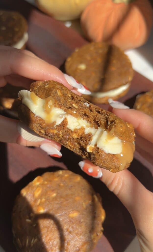 Close-up of a pumpkin oatmeal cream pie with creamy filling.