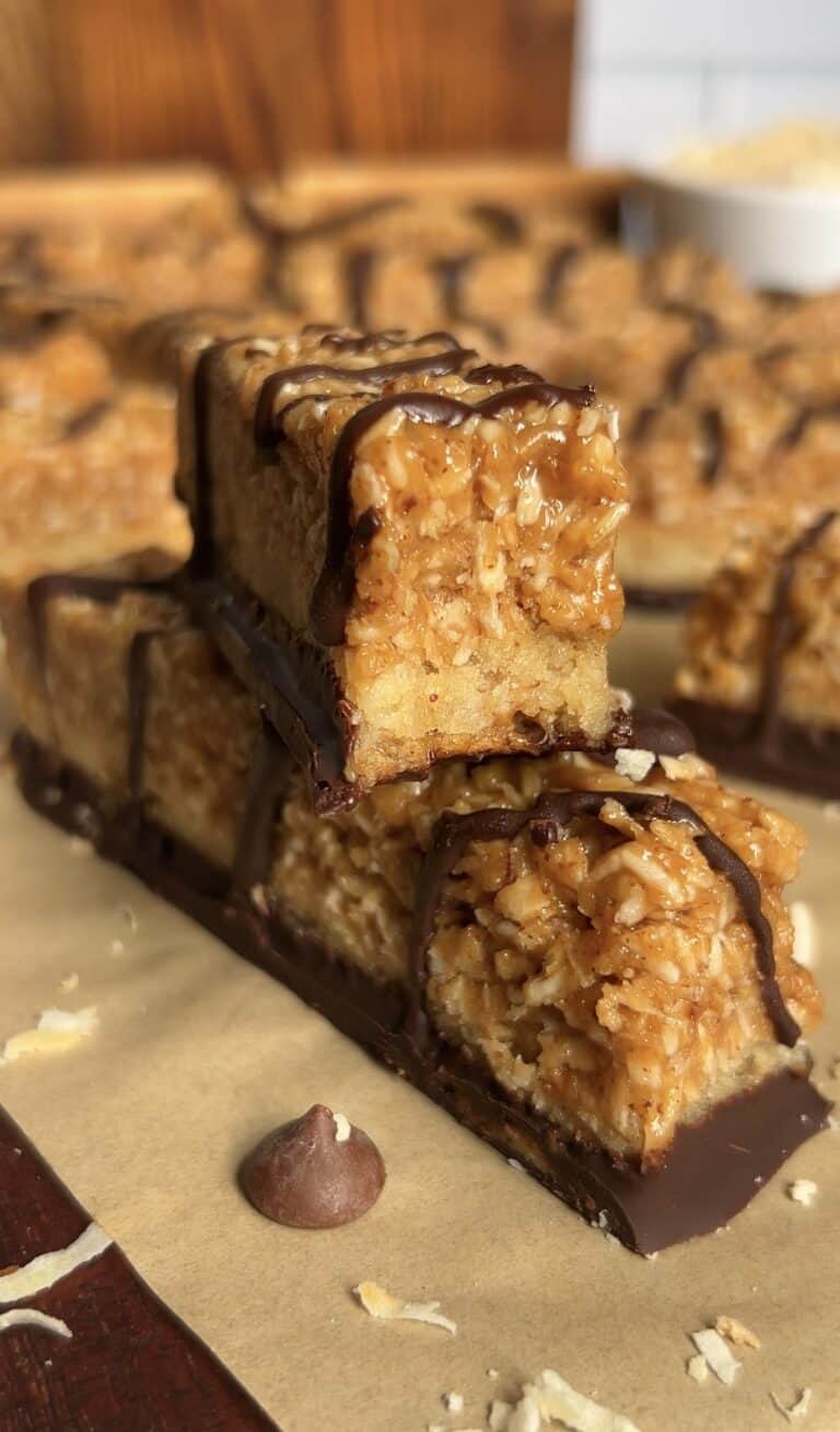 Close-up of caramel coconut cookie bars with chocolate drizzle.