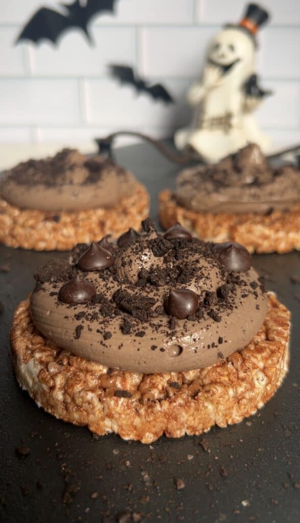 Chocolate protein rice cakes with high protein chocolate yogurt and chocolate chips for a healthy Halloween snack.