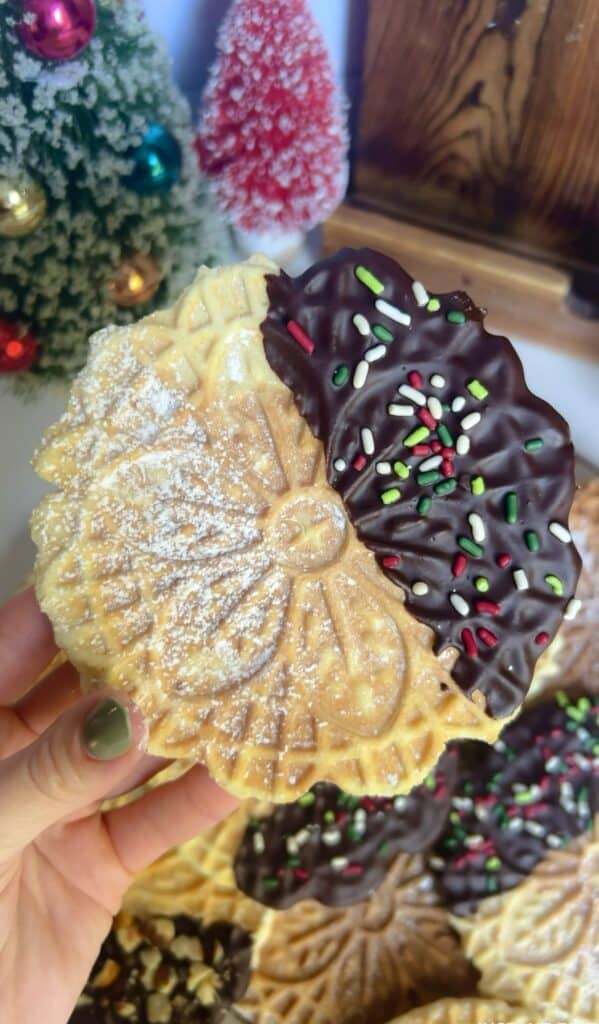 Gluten-free pizzelle with chocolate dip and colorful sprinkles.