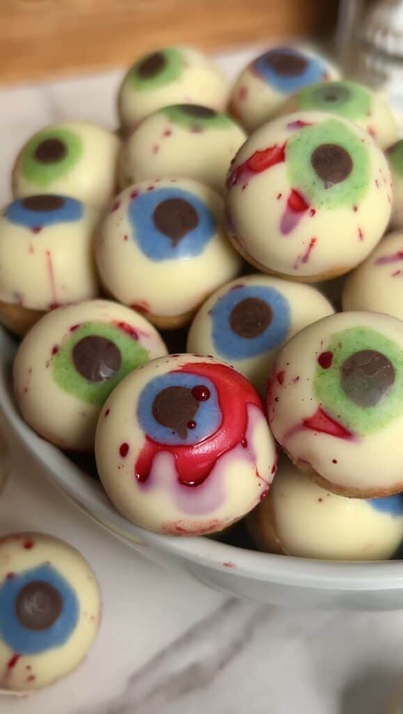 Colorful Halloween eyeball candies with blood-red accents and bloodshot details.
