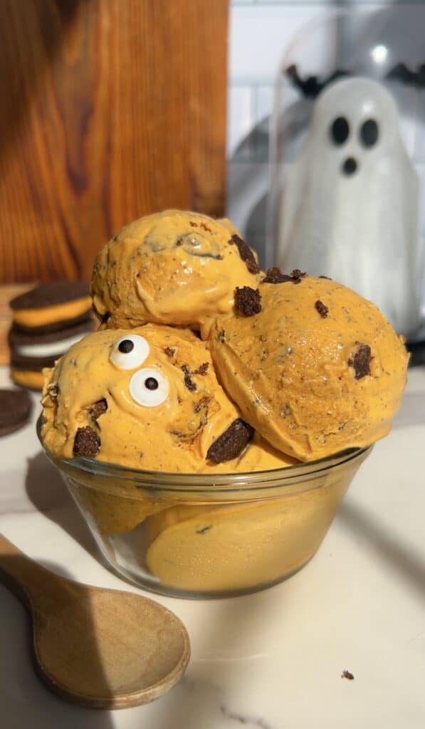High Protein Halloween Cookies and cream ice cream with spooky ghost decoration in background.