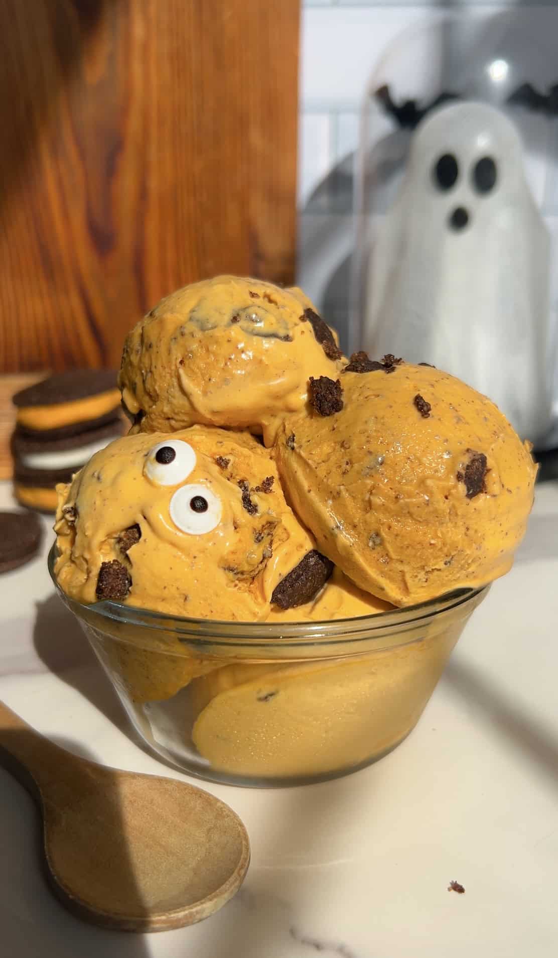 High Protein Halloween Cookies and cream ice cream with spooky ghost decoration in background.