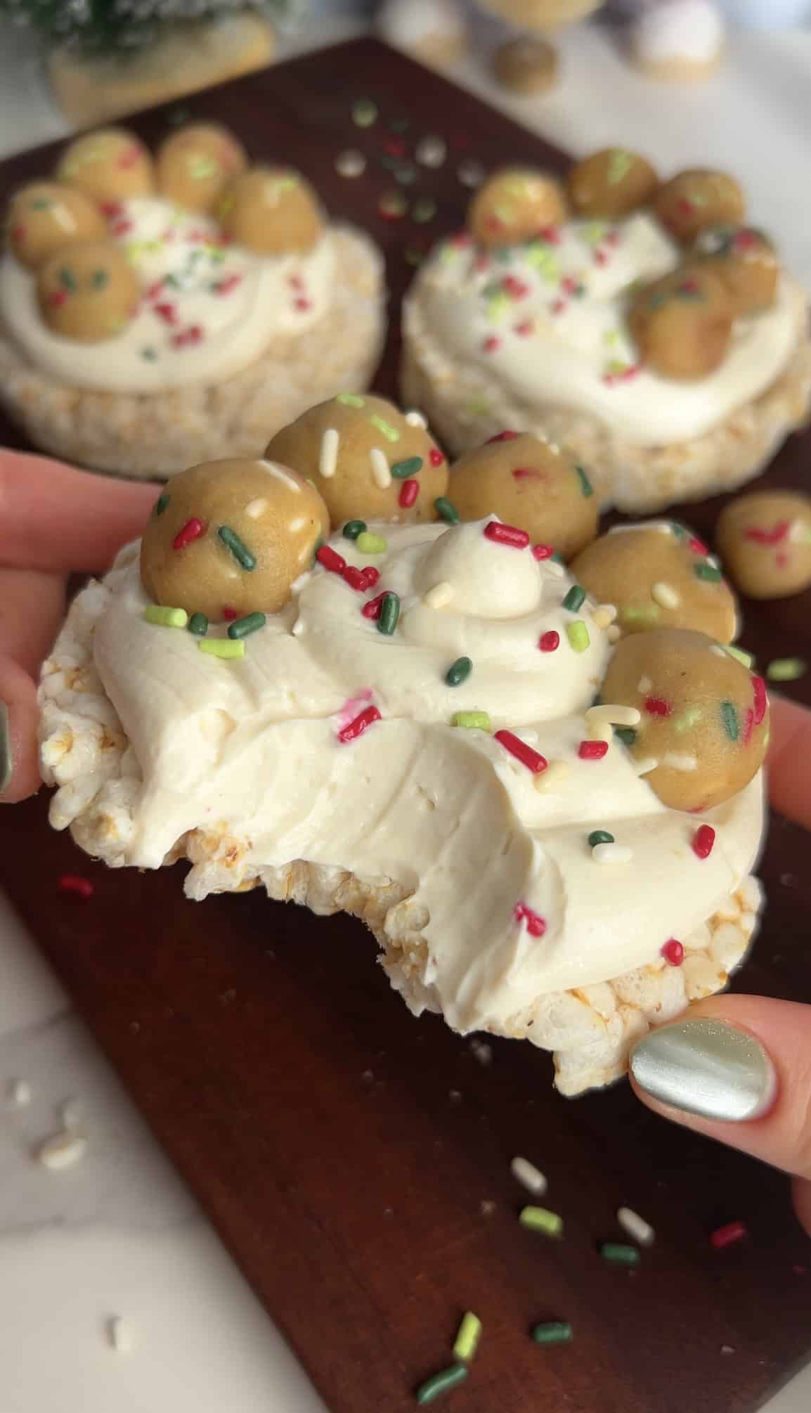 Sugar cookie rice cake with white frosting and sprinkles.